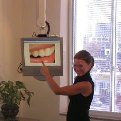 Team member pointing at a smile on a chairside monitor